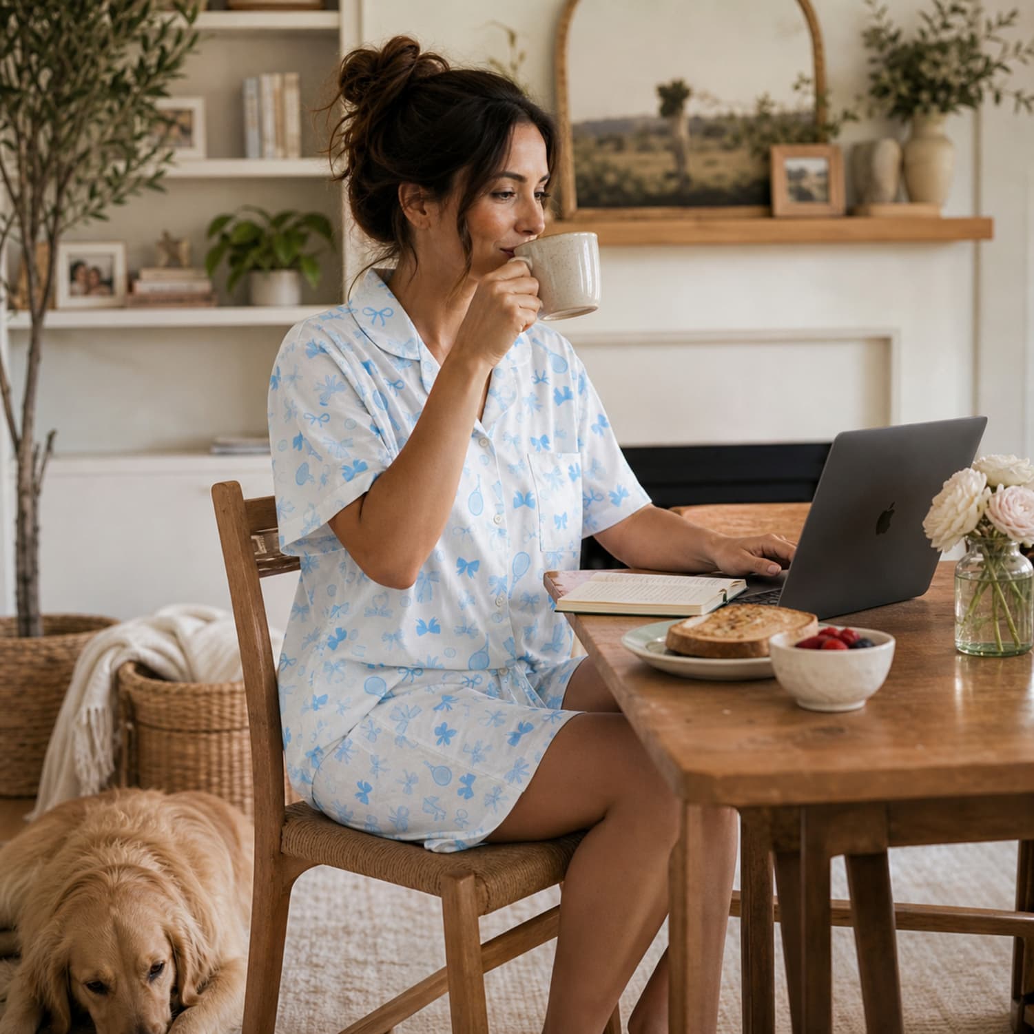 Women sipping coffee wearing pajamas on the computer
