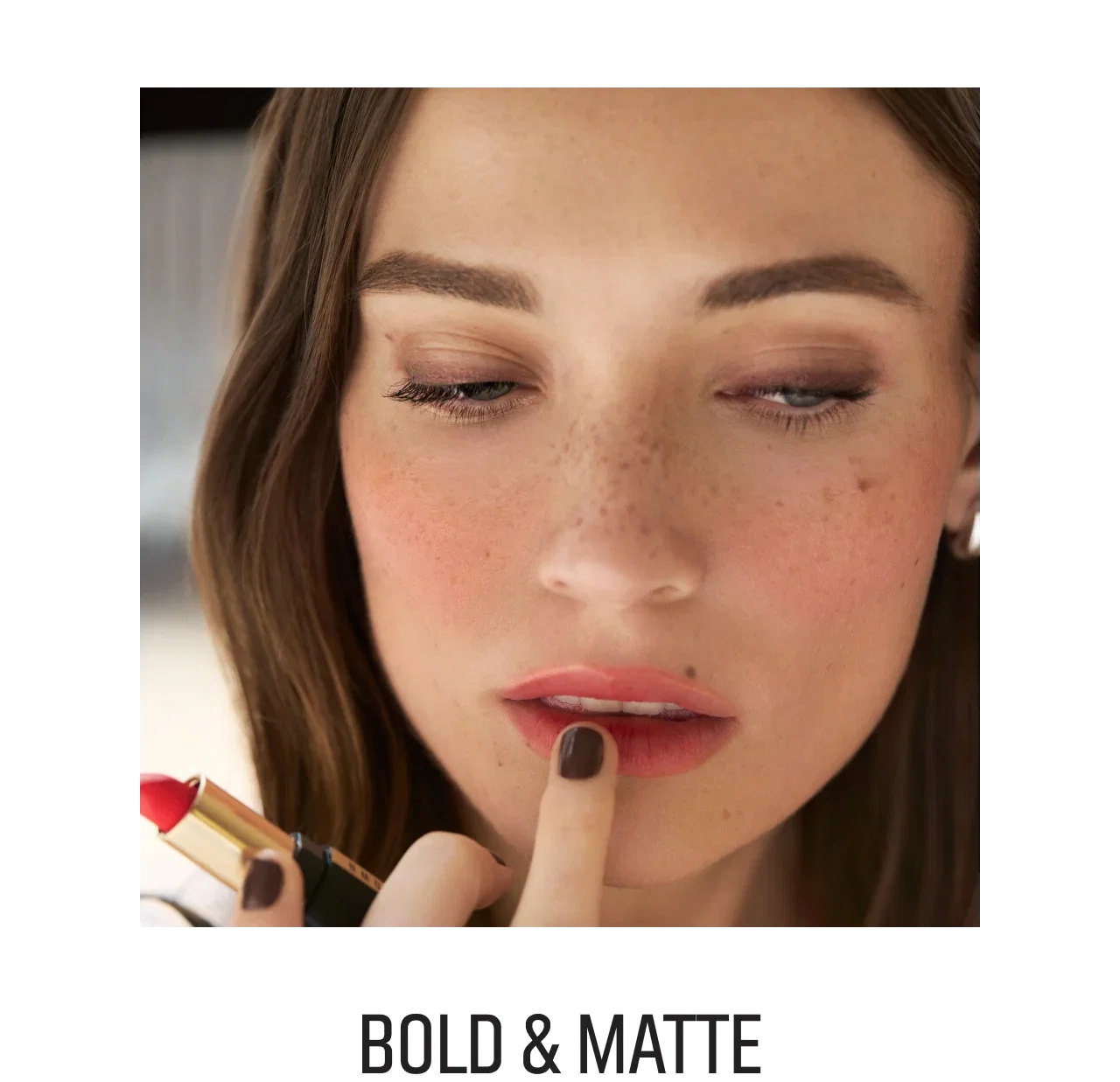 Close-up of a woman applying Luxe Cashmere Matte Lipstick in red
