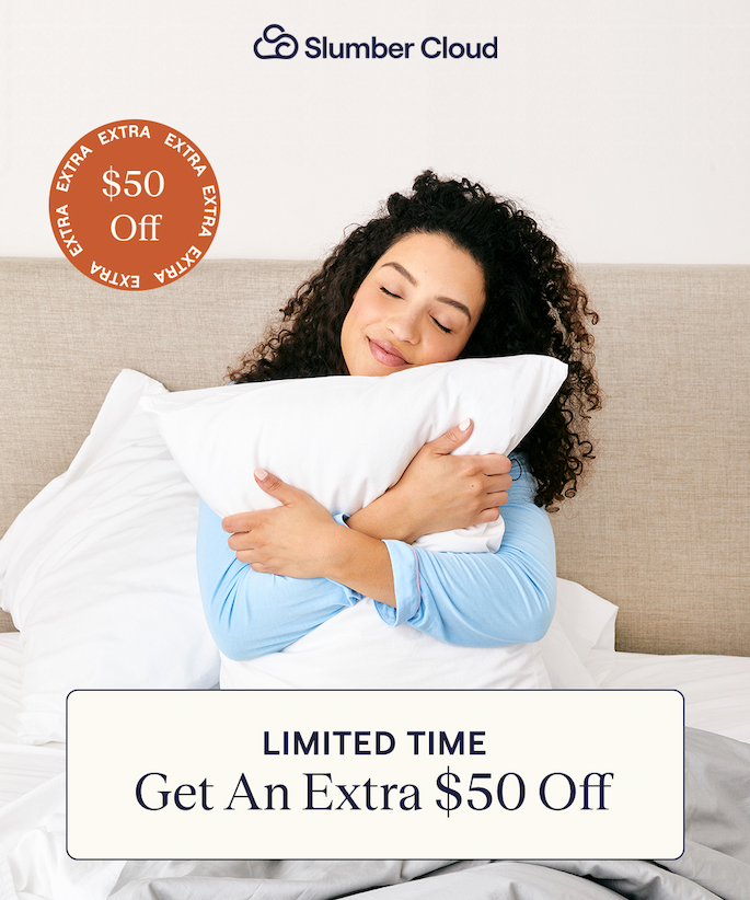 Woman sitting in bed hugging a pillow