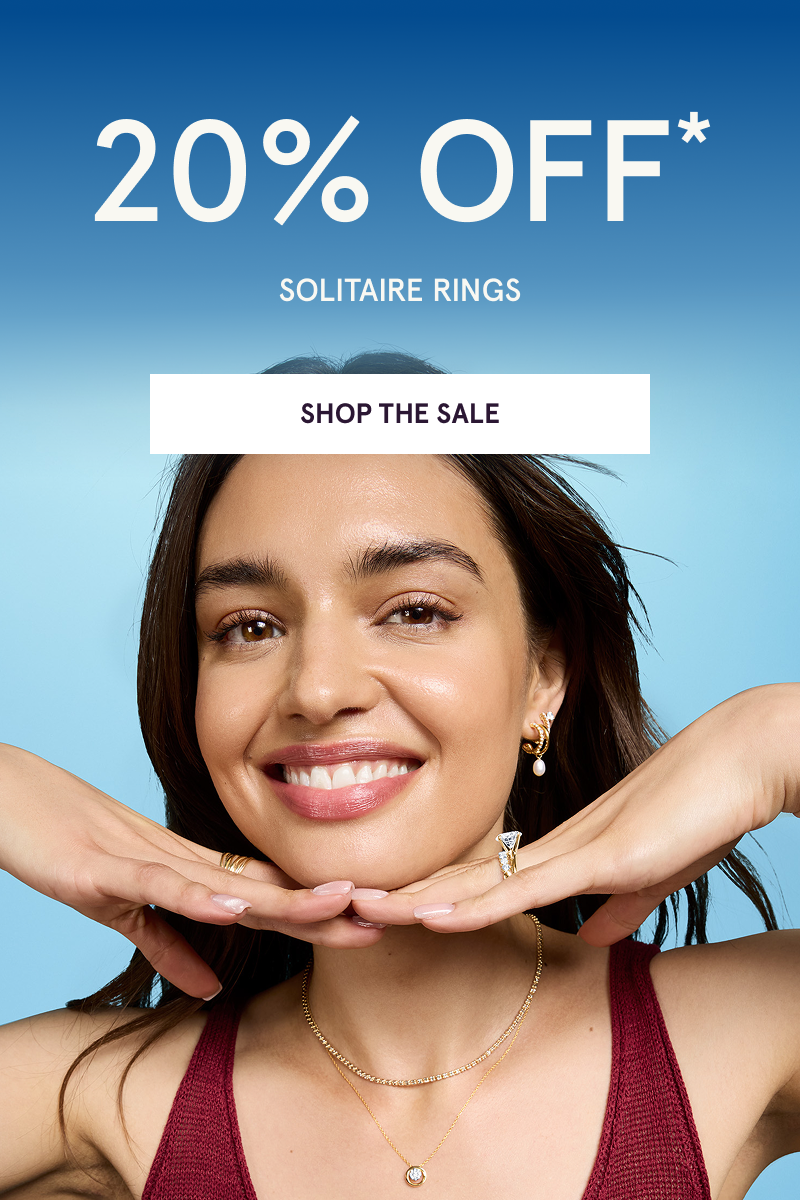 Model wearing gold-focused jewelry styles with diamond ring. 20% OFF Solitaire Rings. Click here to shop the sale.