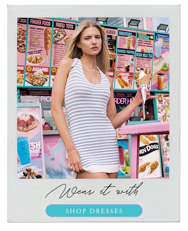 Model wearing a blue striped halter mini dress. Shop dresses. 