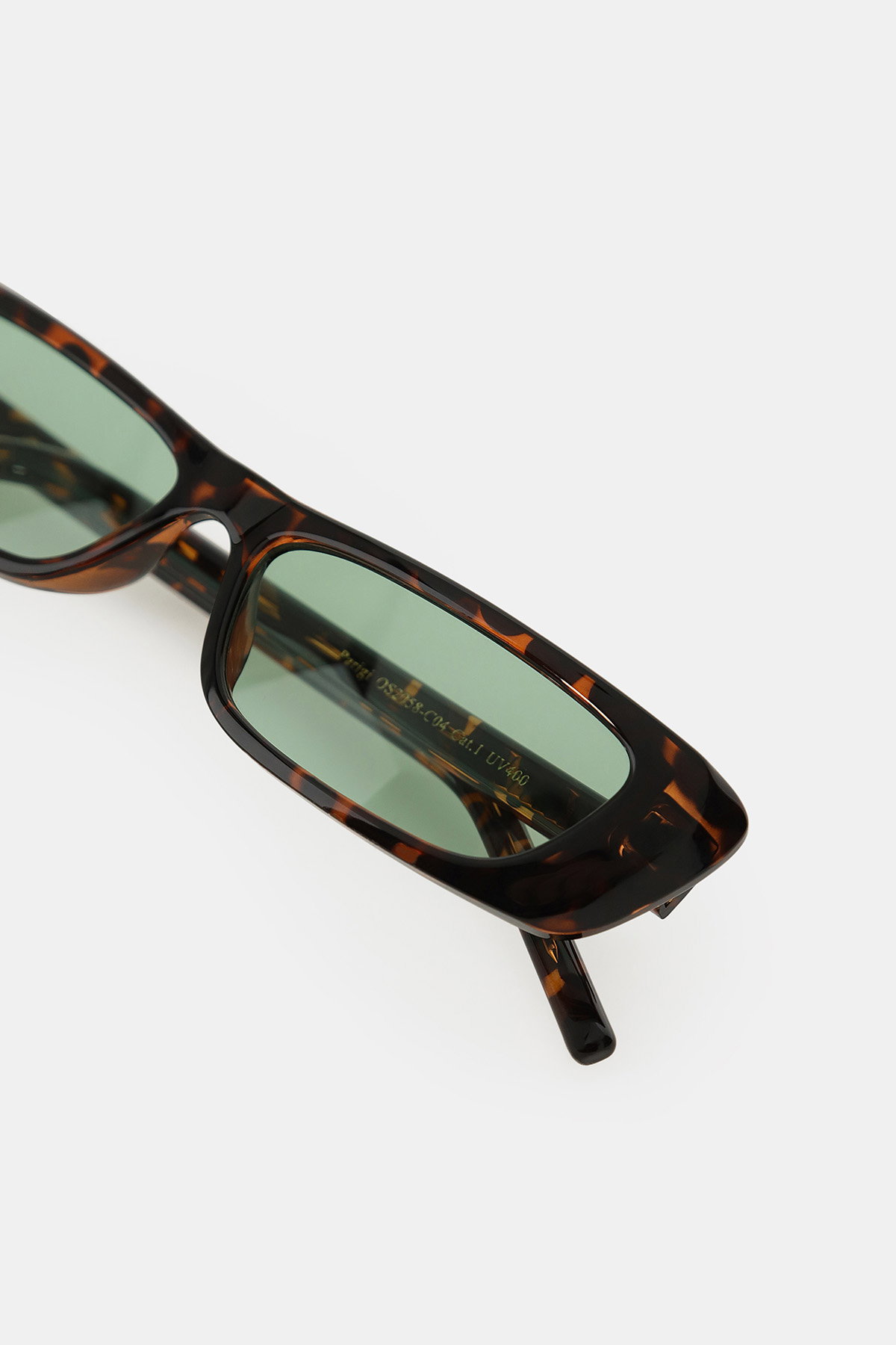 Tortoiseshell rectangular sunglasses with narrow green lenses on white background