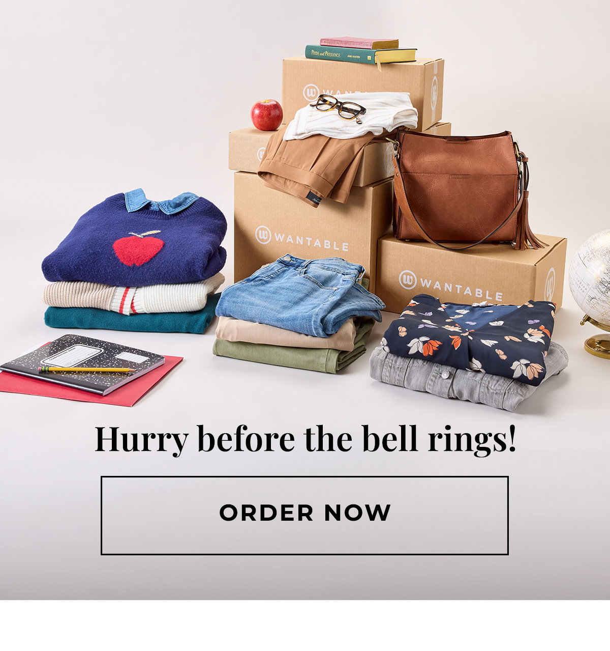 Back to school outfits, notebooks, books, and a leather bag arranged beside Wantable boxes.