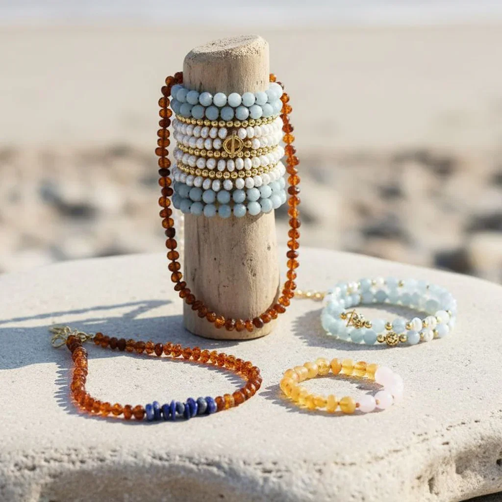 Beaded bracelets and necklaces displayed on wooden stand at beach