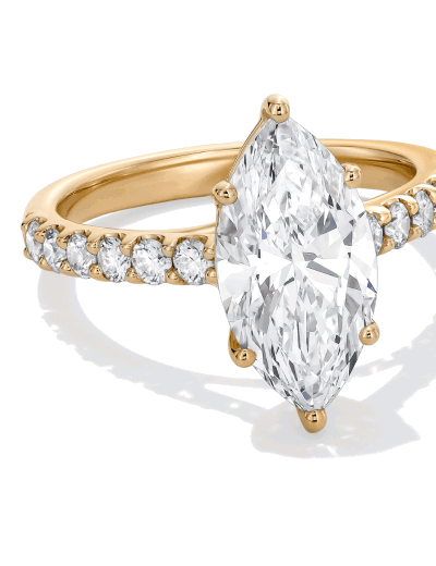 Yellow gold engagement ring with a marquise-cut diamond and pavé diamond band.