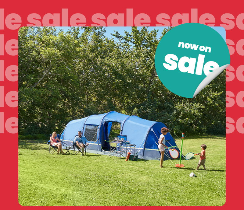 Two people sit in folding chairs near the tent while two children play a lawn game in front. Camping furniture and equipment are arranged outside the tent. The image is framed by a bright red border featuring repeated pale pink “sale” text, with a teal circular graphic partially visible in the bottom-right corner.
