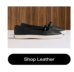 A side view of the Square Toe Mini Bow Leather flats in black. Shop Leather.
