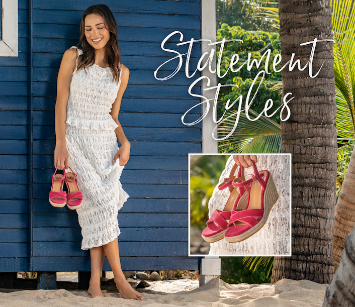 Women holding pink wedge sandals in a tropical environement