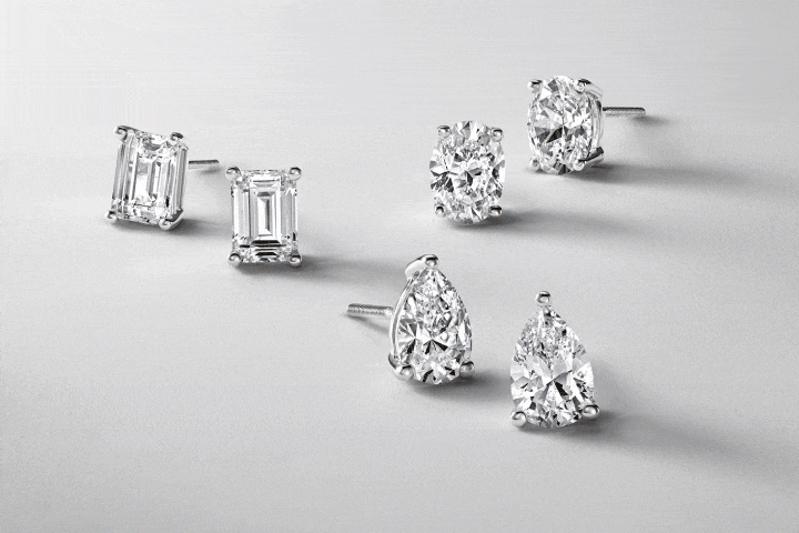 Emerald cut, pear shaped and round diamond solitaire stud earrings. Diamond tennis necklace. Diamond hoop earrings.