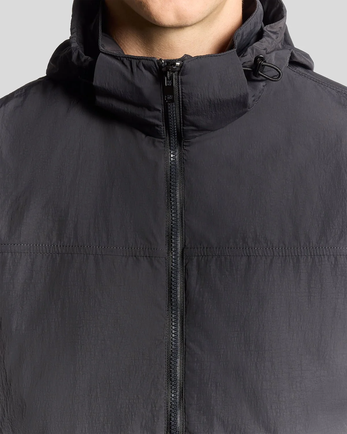 Man wears Water Resistant Packaway Jacket in Black Ice