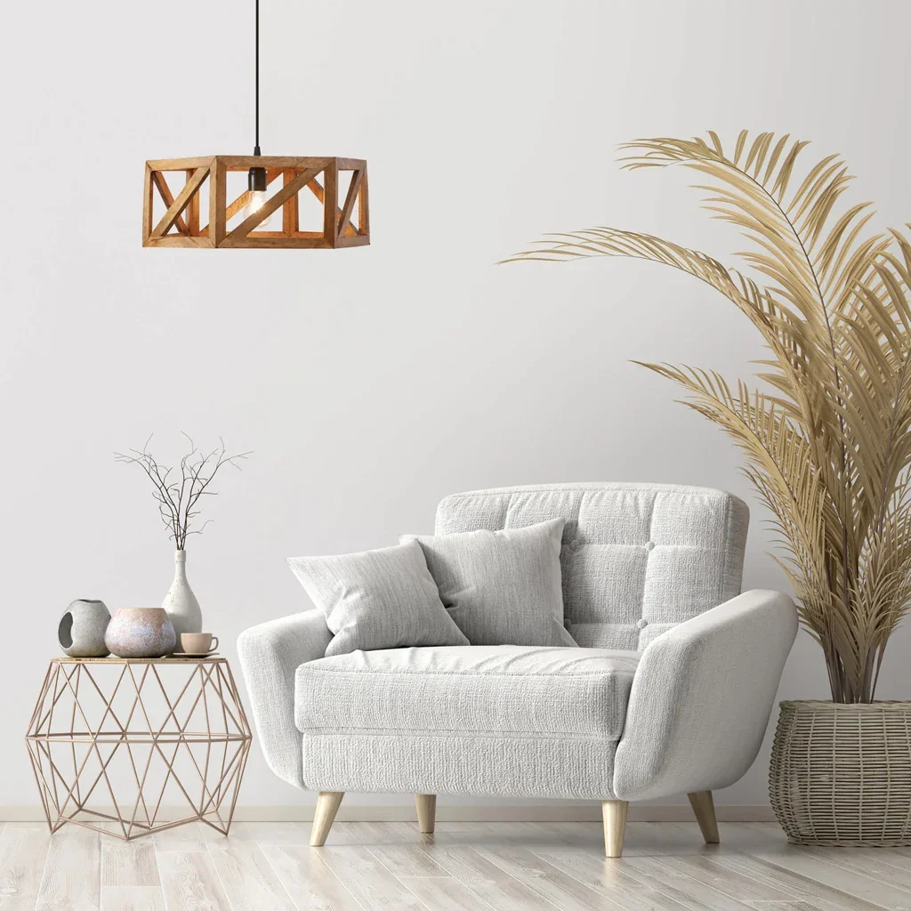 Modern living room with light gray armchair, wooden pendant lamp, geometric side table, and potted palm plant.