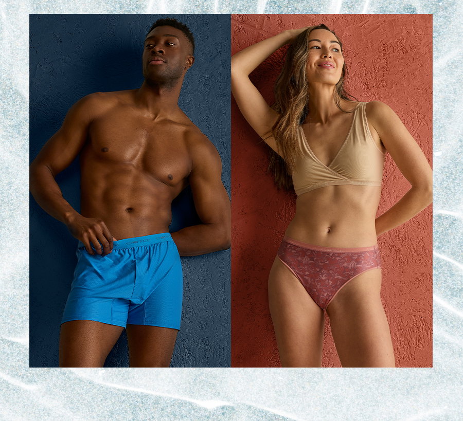 Man in blue ExOfficio boxer briefs standing against a navy textured wall, next to a woman in a taupe bralette and rust floral underwear set against a terracotta textured wall.