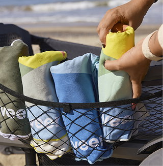 Close-up of colorful towels secured inside a Cruiser with a cargo net