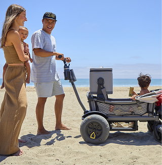 Family walking on the beach with a Cruiser featuring a cargo net holding a cooler and beach gear