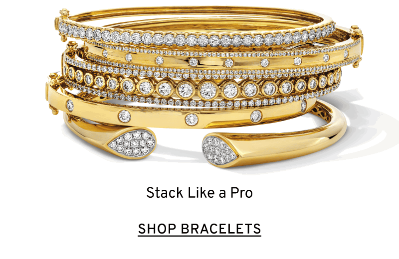 A stack of gold and diamond bangles. Stack like a pro. Click to Shop Bracelets