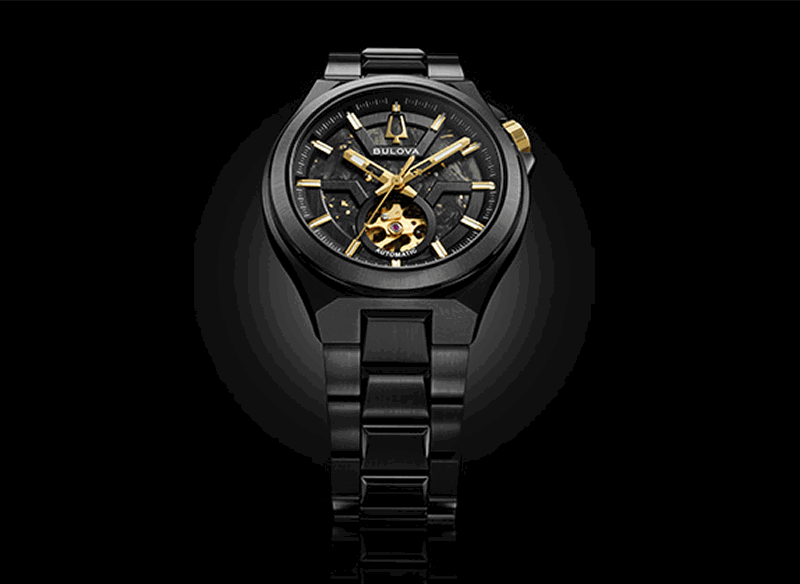 Black Bulova Maquina automatic watch with gold-tone accents and an open-heart dial.