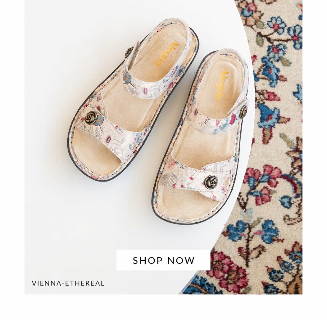 Pair of Alegria Vienna Ethereal floral-patterned adjustable strap sandals displayed on a white surface with a Shop Now button.