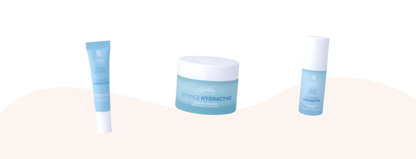Three pale-blue Defence Hydractive skincare products (tube, jar, pump bottle) on white background