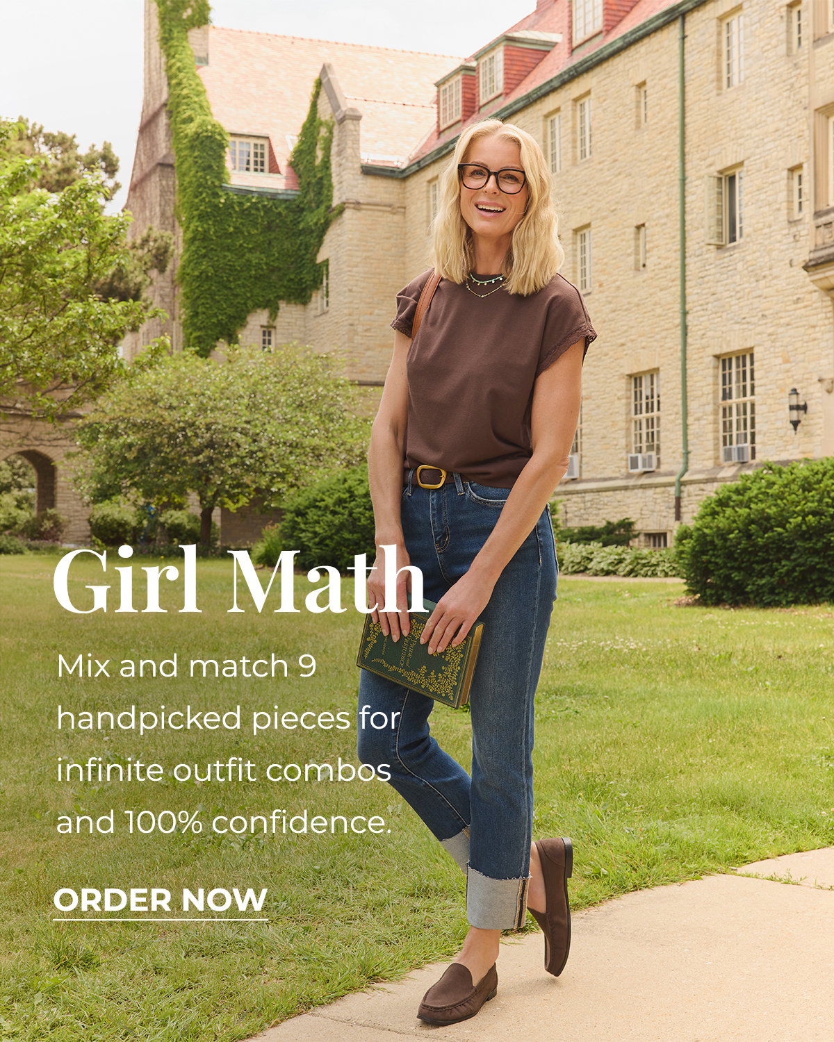 Woman in brown top and cuffed jeans holds a book on a leafy college campus.