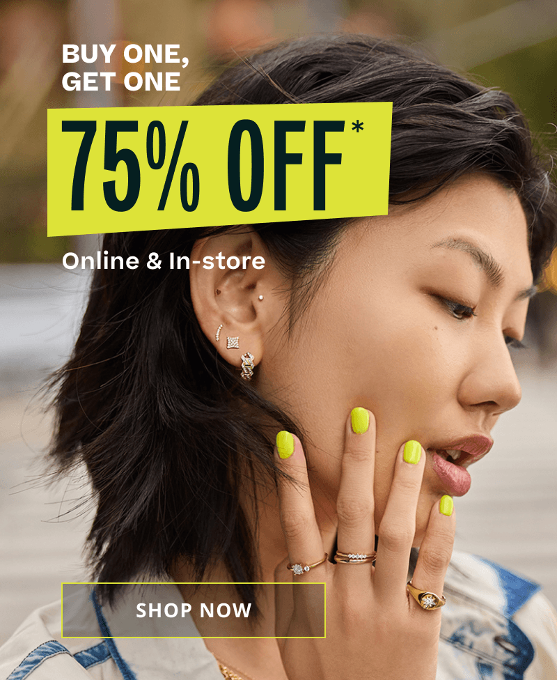Model wearing thick gold-set jewelry with diamond accents. BOGO 75% OFF. Online & in-store.  Click here to shop now