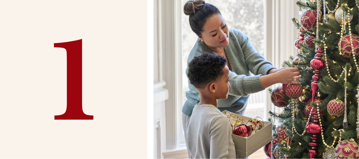 Mom and son decorating an artificial tree