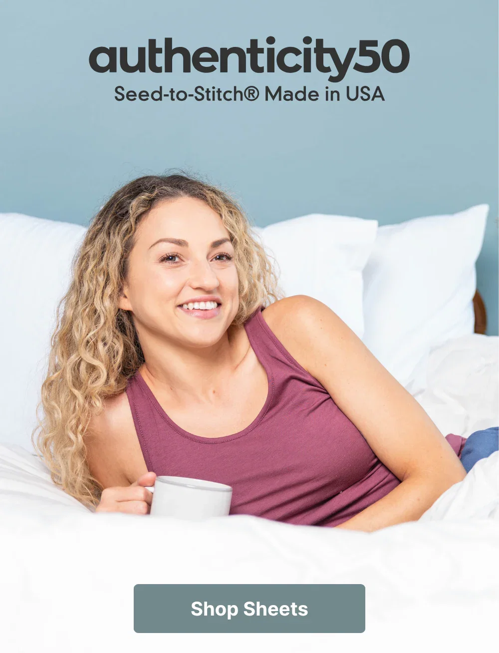 Woman lying in bed (made with Cloud White Heritage American Sheets) with a cup of coffee. Click or tap to shop sheets.