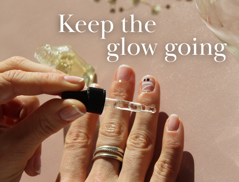 Hand applying cuticle oil to manicured nails. Text reads, "Keep the glow going."