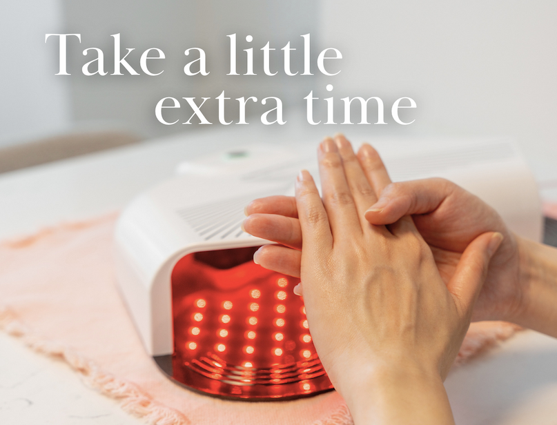 Hands moisturizing after using an LED nail lamp. Text reads, "Take a little extra time."