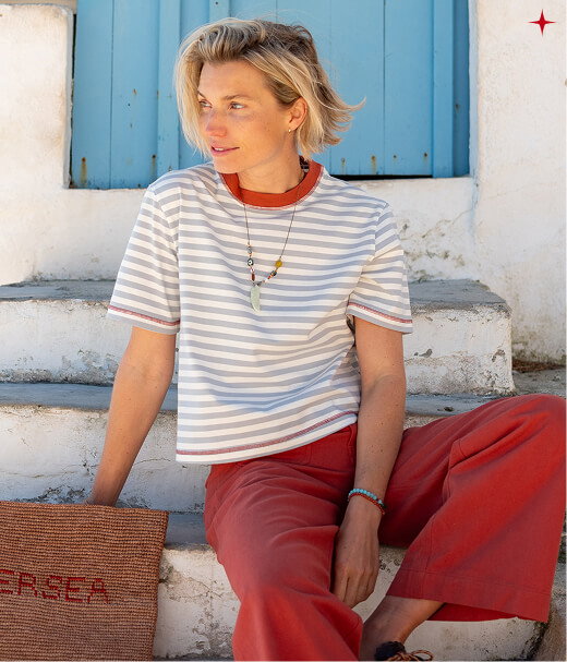 Image of a woman wearing a light blue striped short sleeve tee