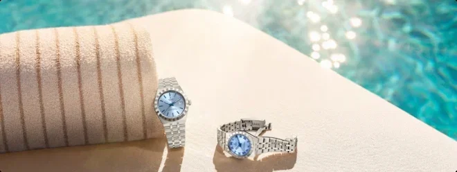 TUDOR blue dial luxury watch by a swimming pool in summer