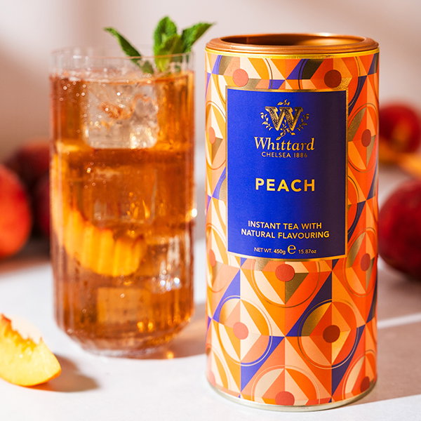 image of peach instant tea tub with made up drink and fruit around on tennis court