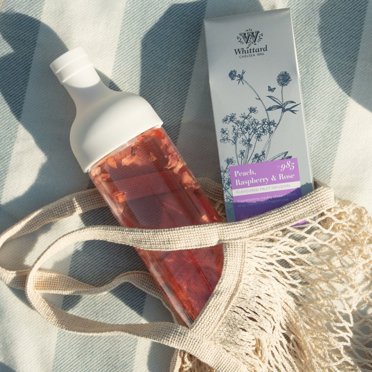 image of white hario cold brew bottle and peach raspberry rose infusion in bag 