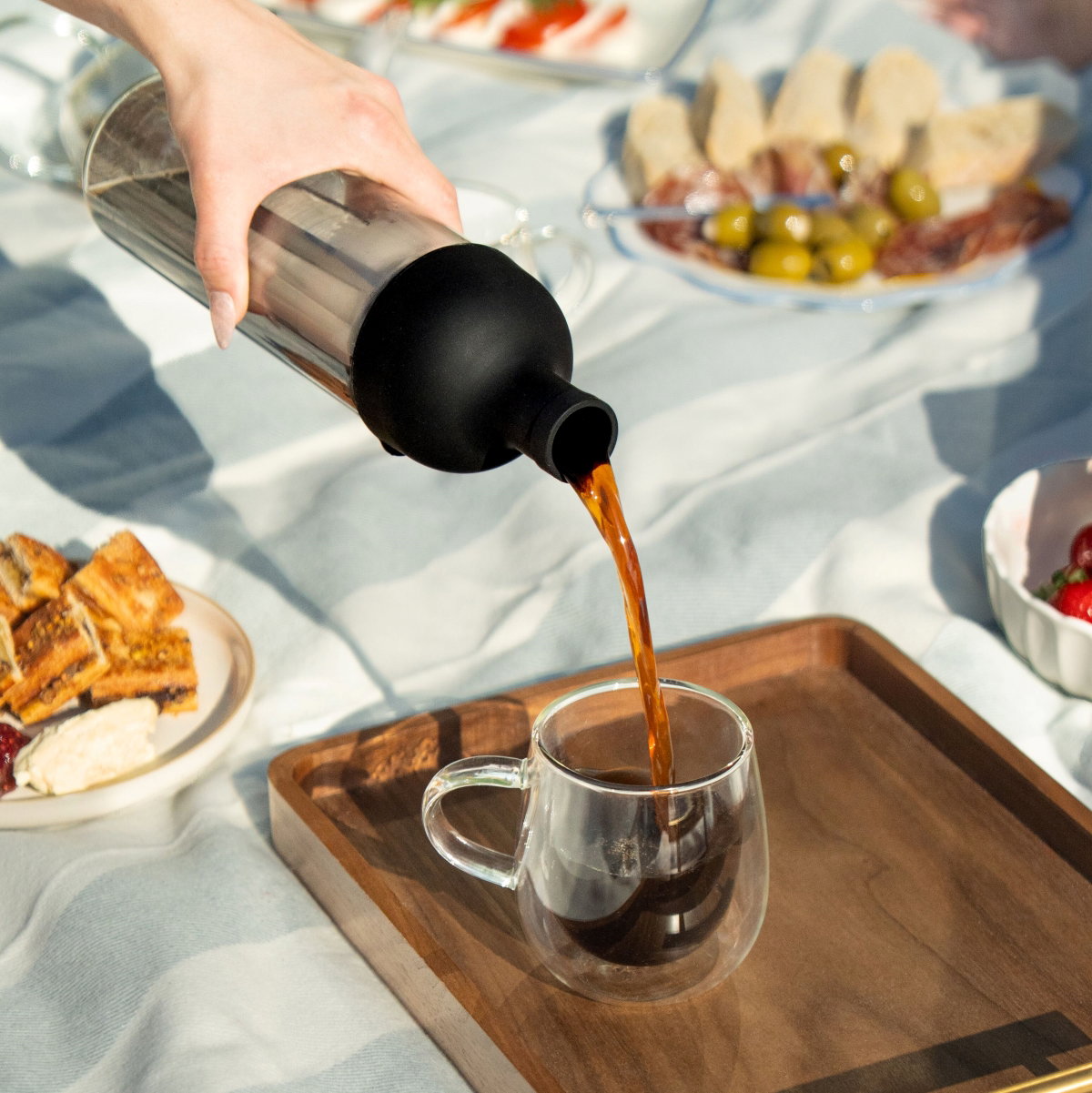image of cold brew coffee bottle being poured into nova glass
