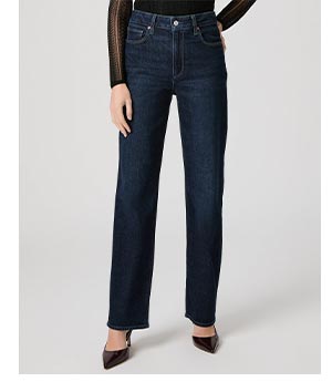 Image of a woman's legs in a pair of dark blue denim jeans.