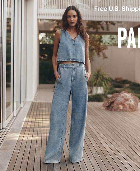 A woman wearing a sleeveless denim top and matching wide leg jeans.
