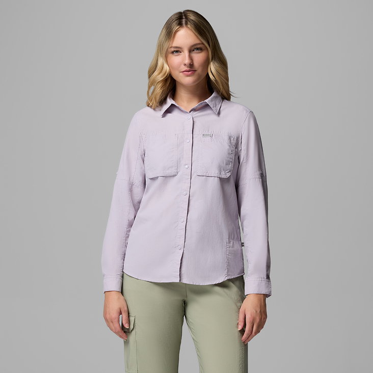 A woman wearing a purple long sleeve button-up top.