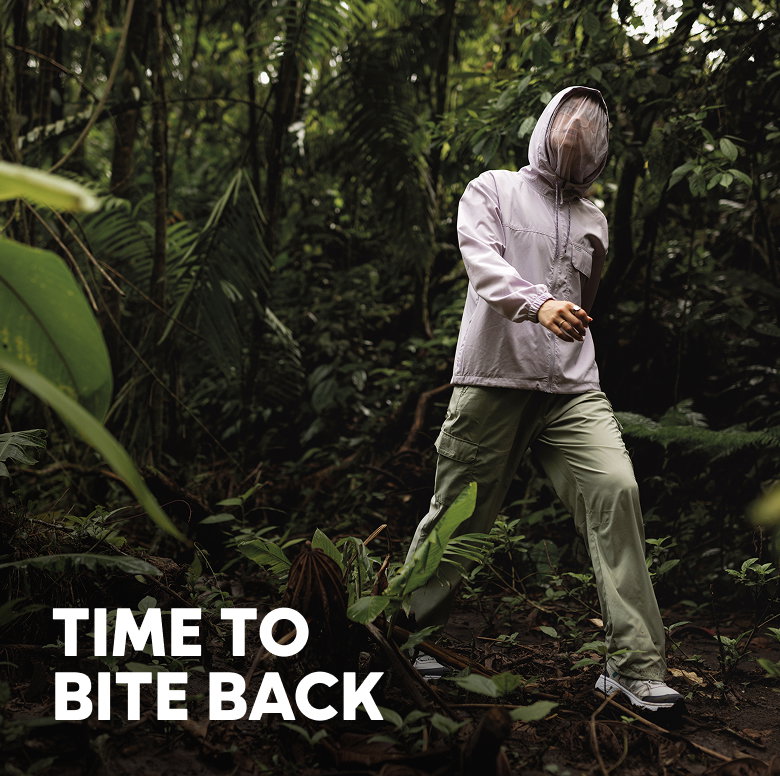 A woman walking in a lush jungle with text: TIME TO BITE BACK
