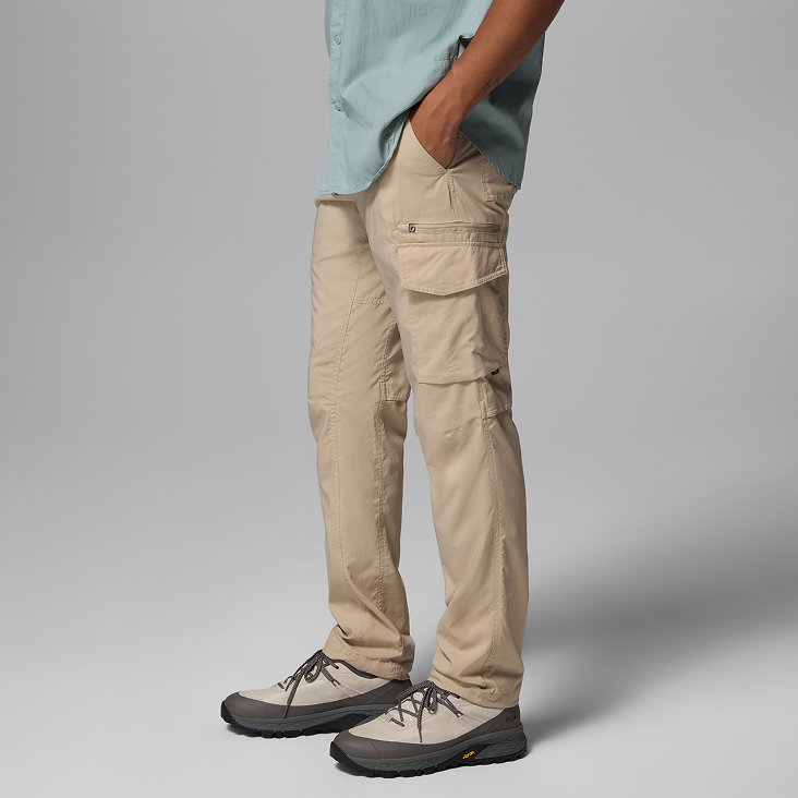 Waist-down image of a man wearing tan pants and hiking shoes.