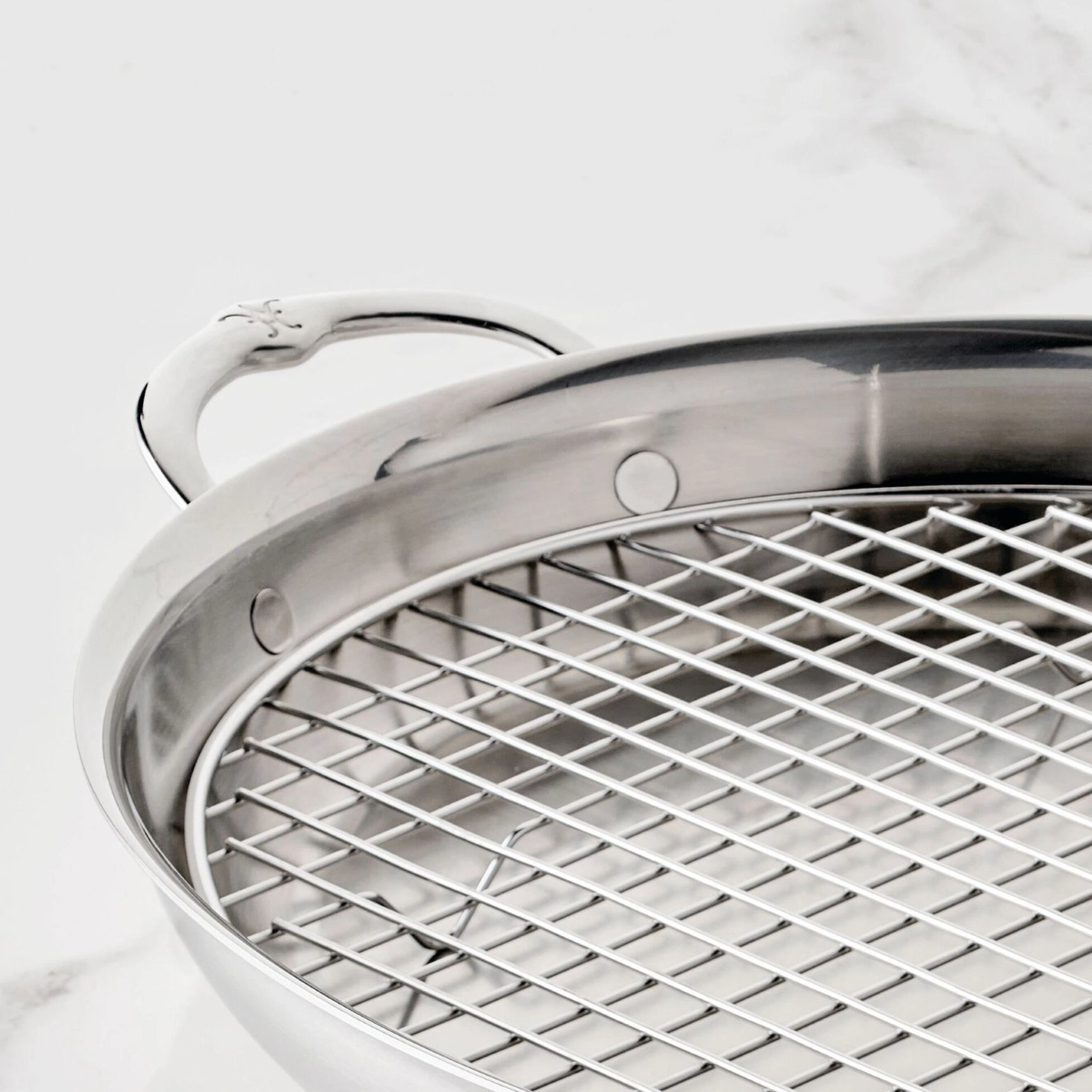 IMG: Closeup of Hestan Large Oval Roaster flush rivets and handle