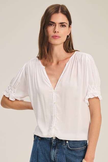 Image shows a model wearing the Carmella Top in White.