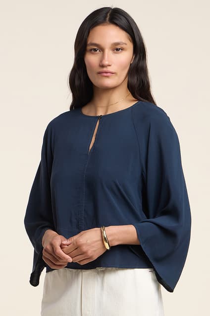 Image shows a model wearing the Raegan Top in Navy.