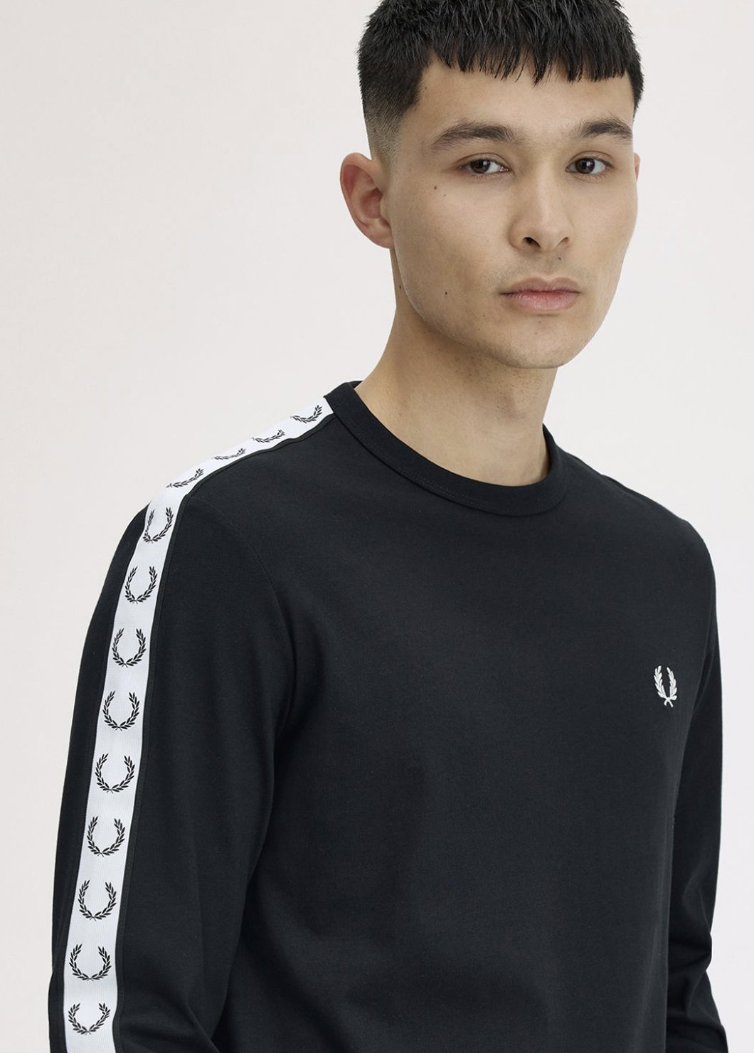 Male model wearing a Fred Perry Taped Long Sleeve T-Shirt in Black