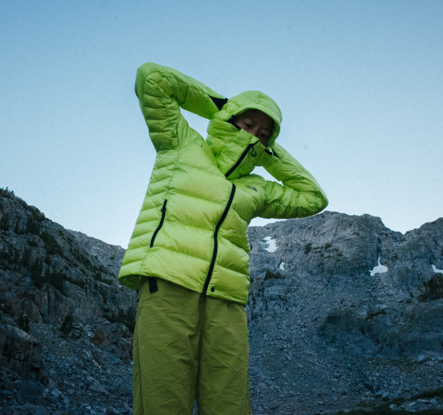 A camper wearing the Phantom™ Alpine Hooded Jacket.