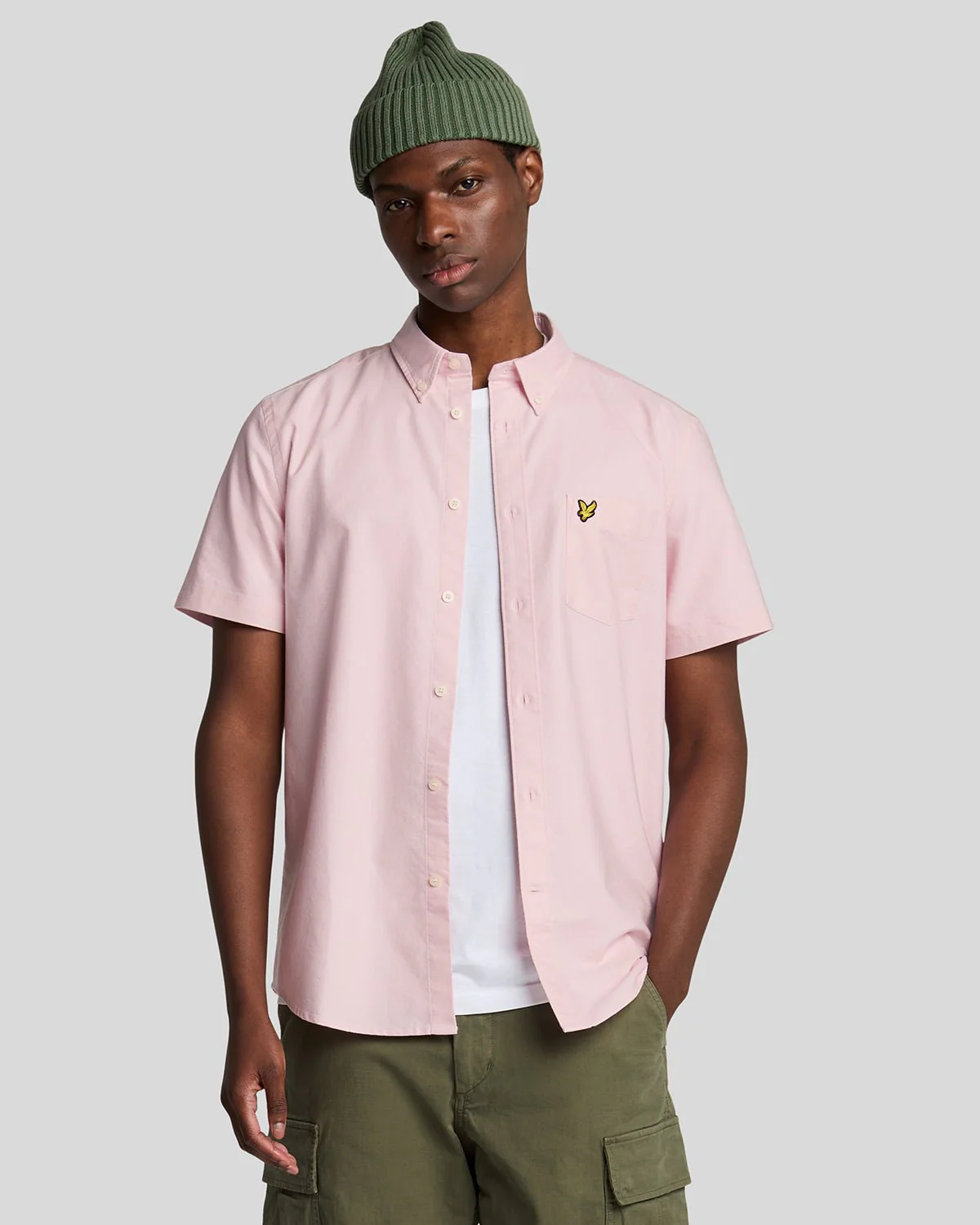Man wears Short Sleeve Oxford Shirt in Light Pink
