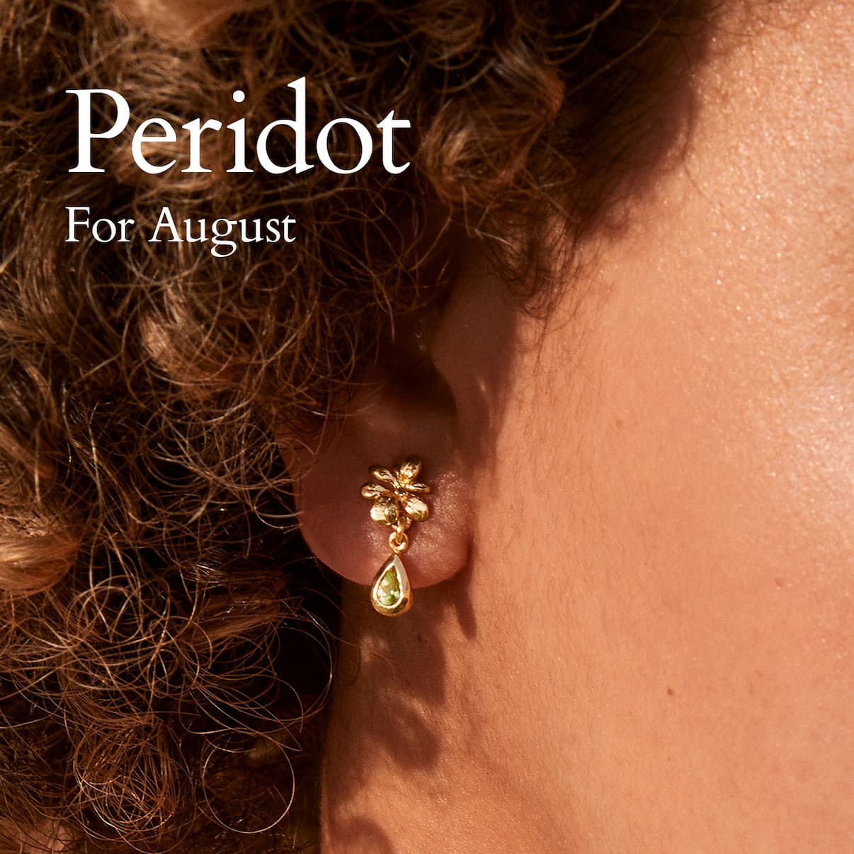 Model wearing a gold peridot fSmall Rosette Peridot Hanging Teardrop Earrings, celebrating August's birthstone.