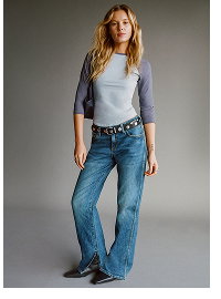 Woman wearing grey cardigan and blue jeans