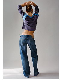 Model wearing purple hoodie and blue jeans from behind