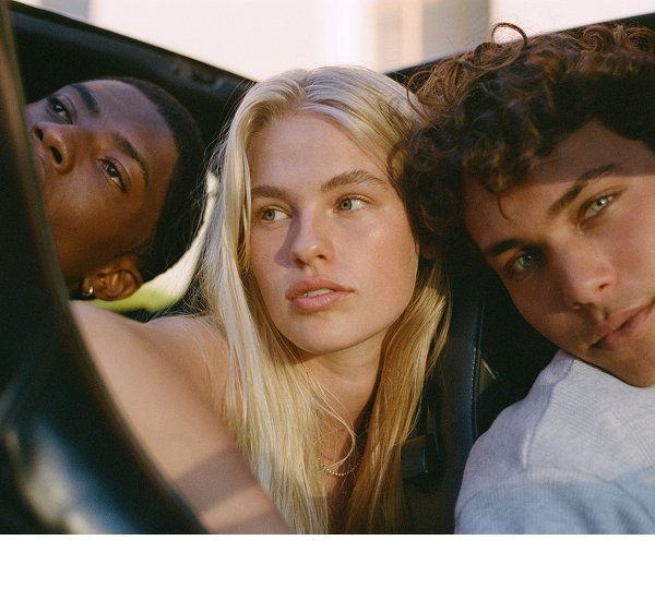 Three diverse young people posing together for fashion campaign