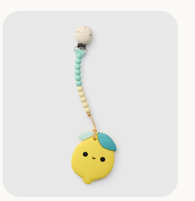 smiling lemon teether attached to a blue and yellow silicone pacifier clip 