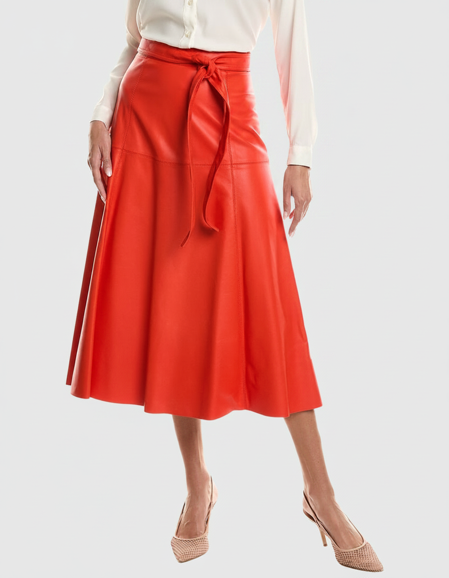 Woman in a red leather midi skirt and white blouse with nude heels.